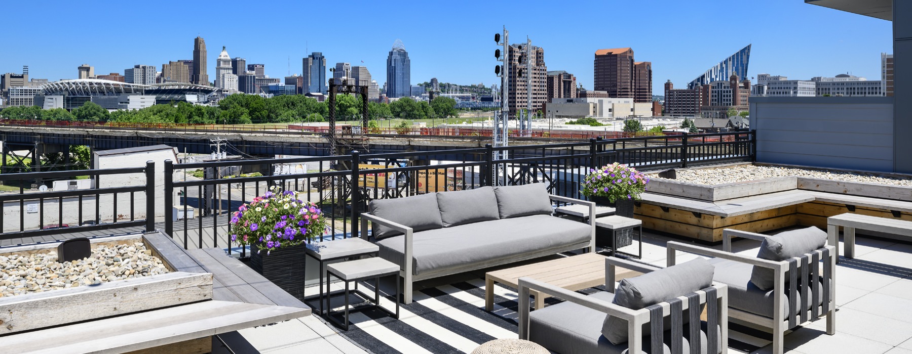 an outdoor lounge with a couch and chairs