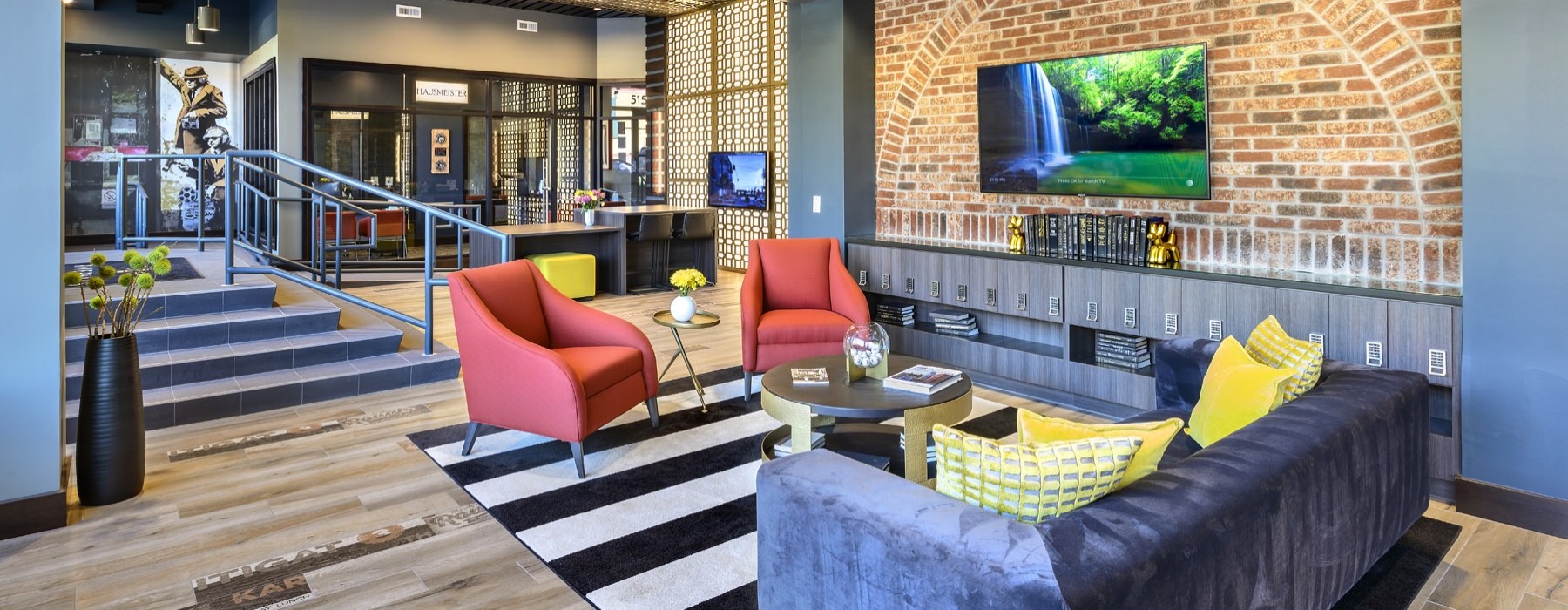 a clubroom with a tv, couch and chairs